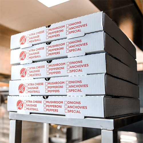 Stack of custom printed white pizza boxes