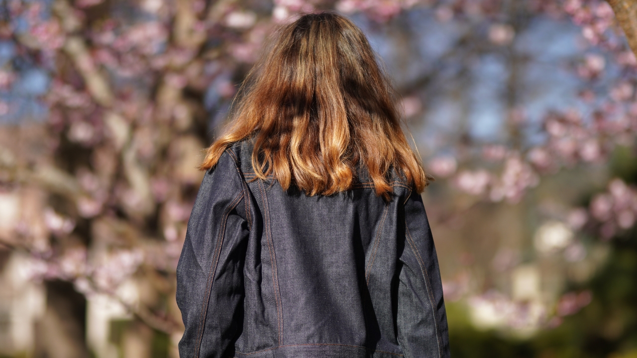 Wearing Nudie Jeans' Jacket With Cherry Blossoms in Background