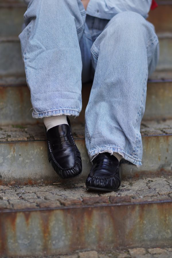 Wearing ALOHAS' Shoes Against a Rustic Background
