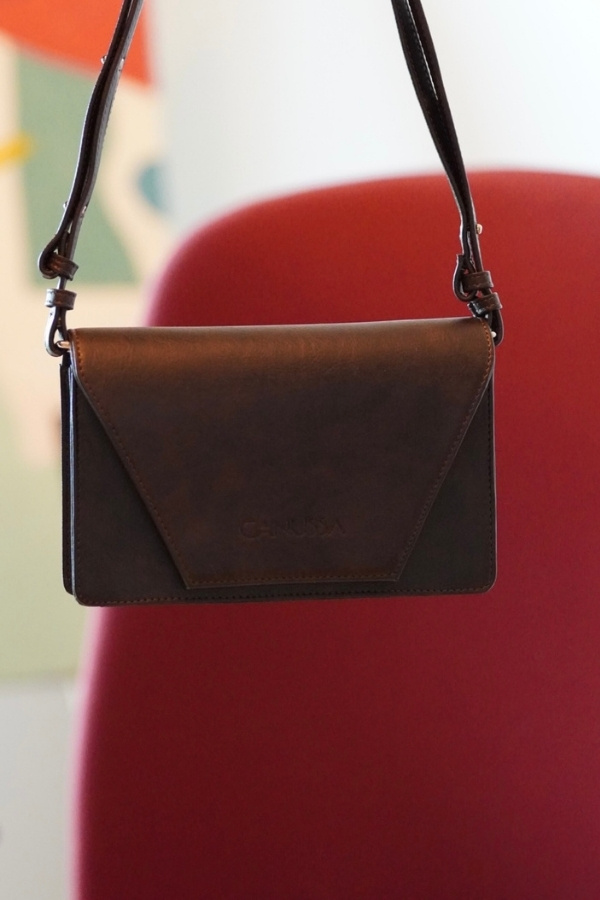 Canussa Vegan Leather Bag Against a Red Background