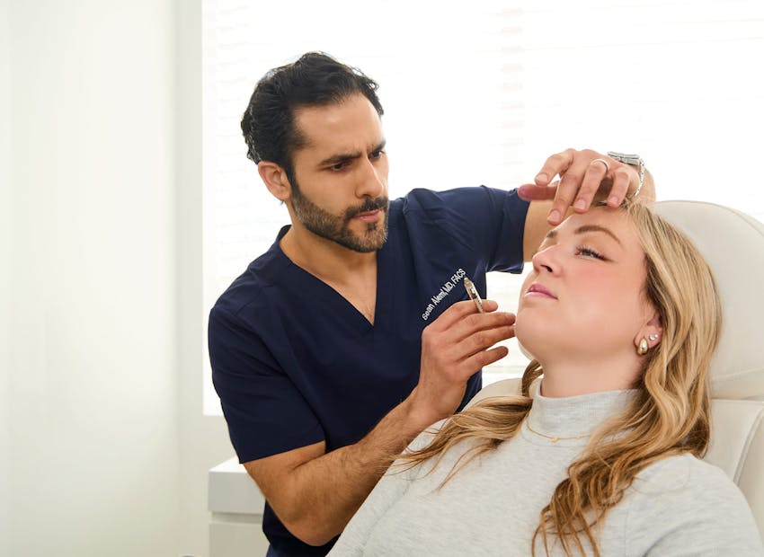 Dr. Alemi checking client's face