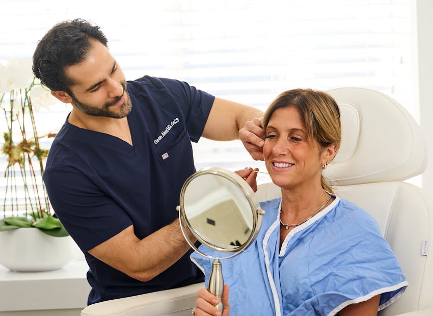 Dr. Alemi checking client's jaw line