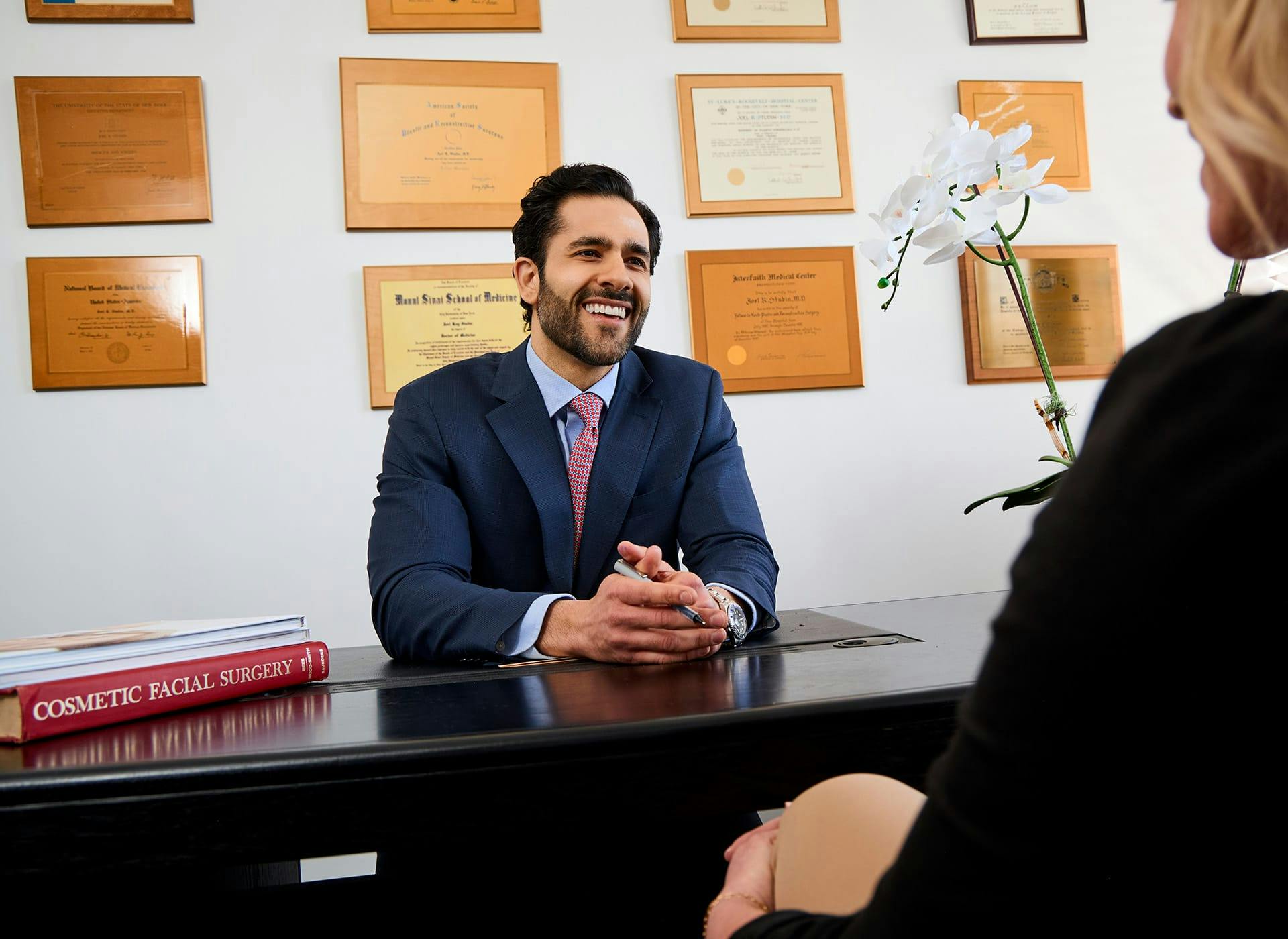 Dr. Alemi sitting at desk