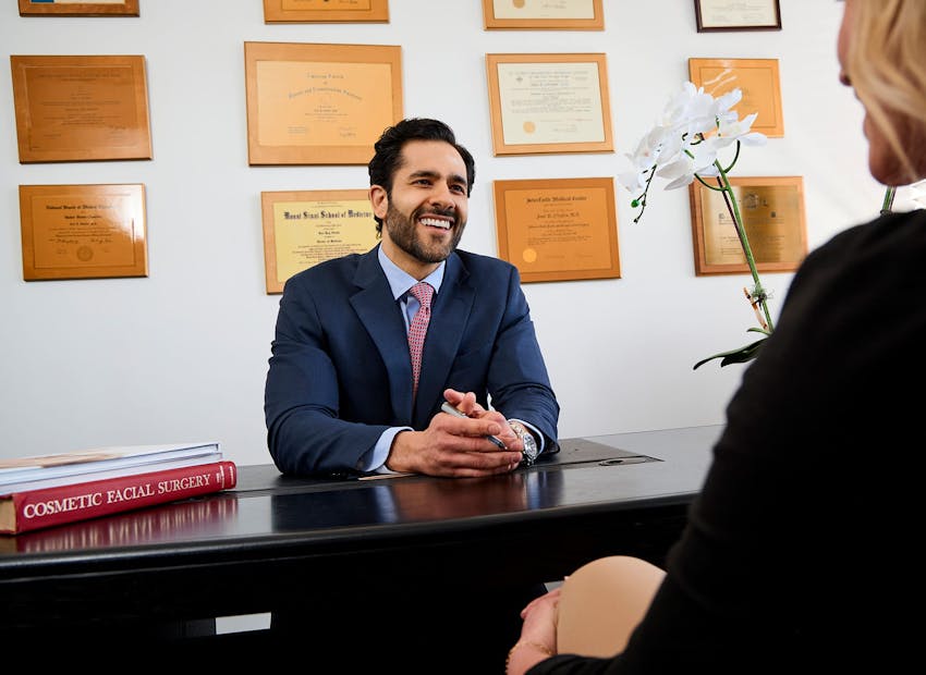 Dr. Alemi sitting at desk