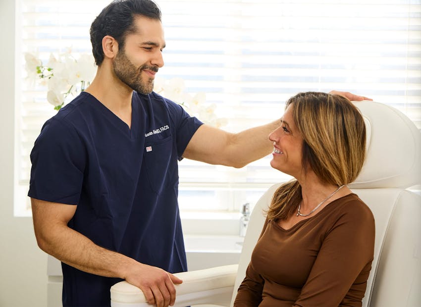 Dr. Alemi smiling at client while she's sitting