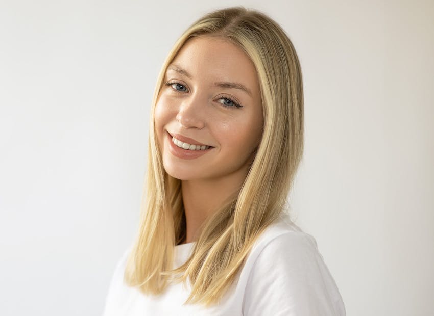 woman with blonde hair in white shirt