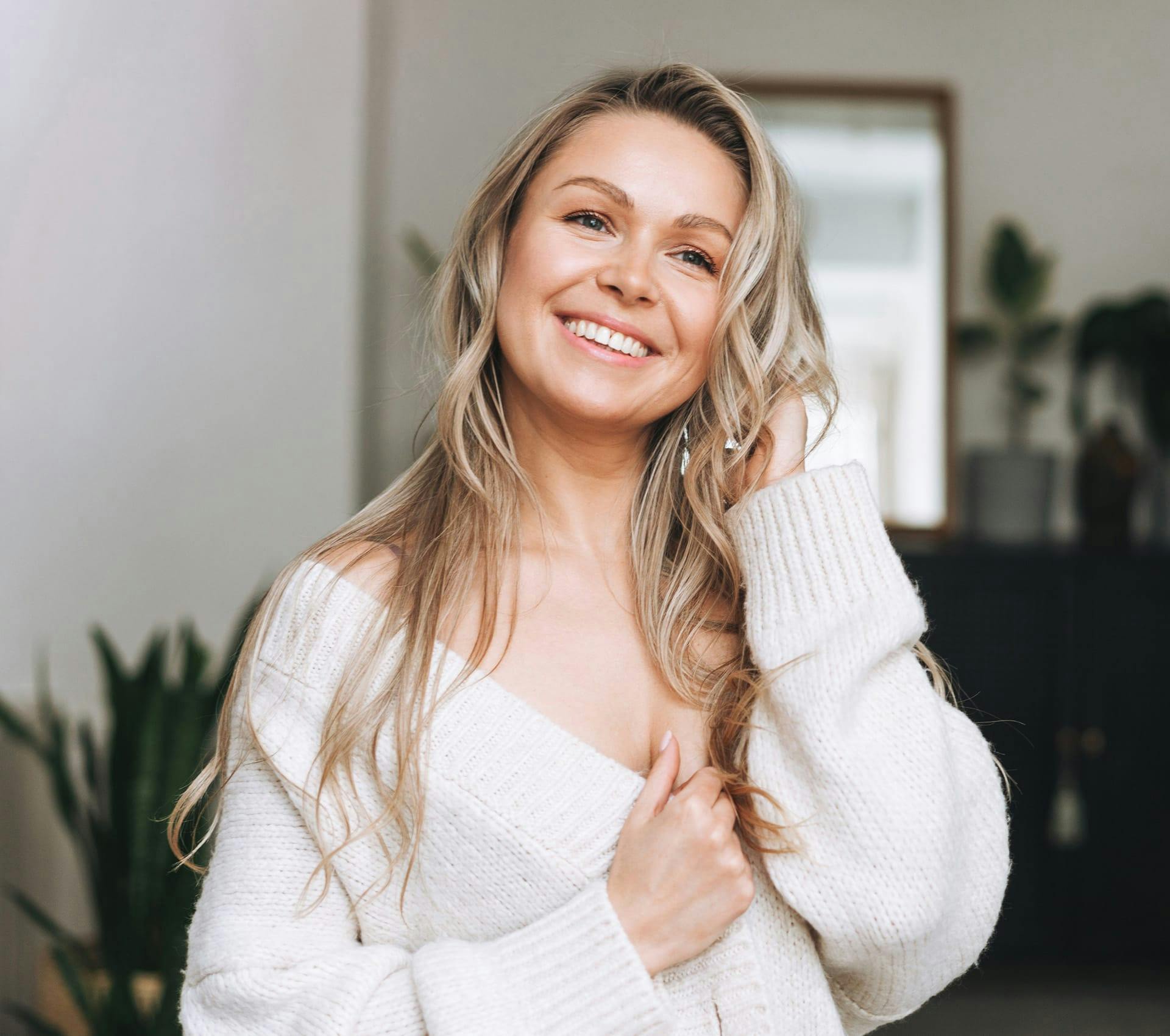 blonde woman in white cardigan