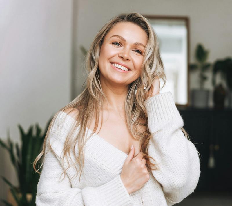 blonde woman in white cardigan