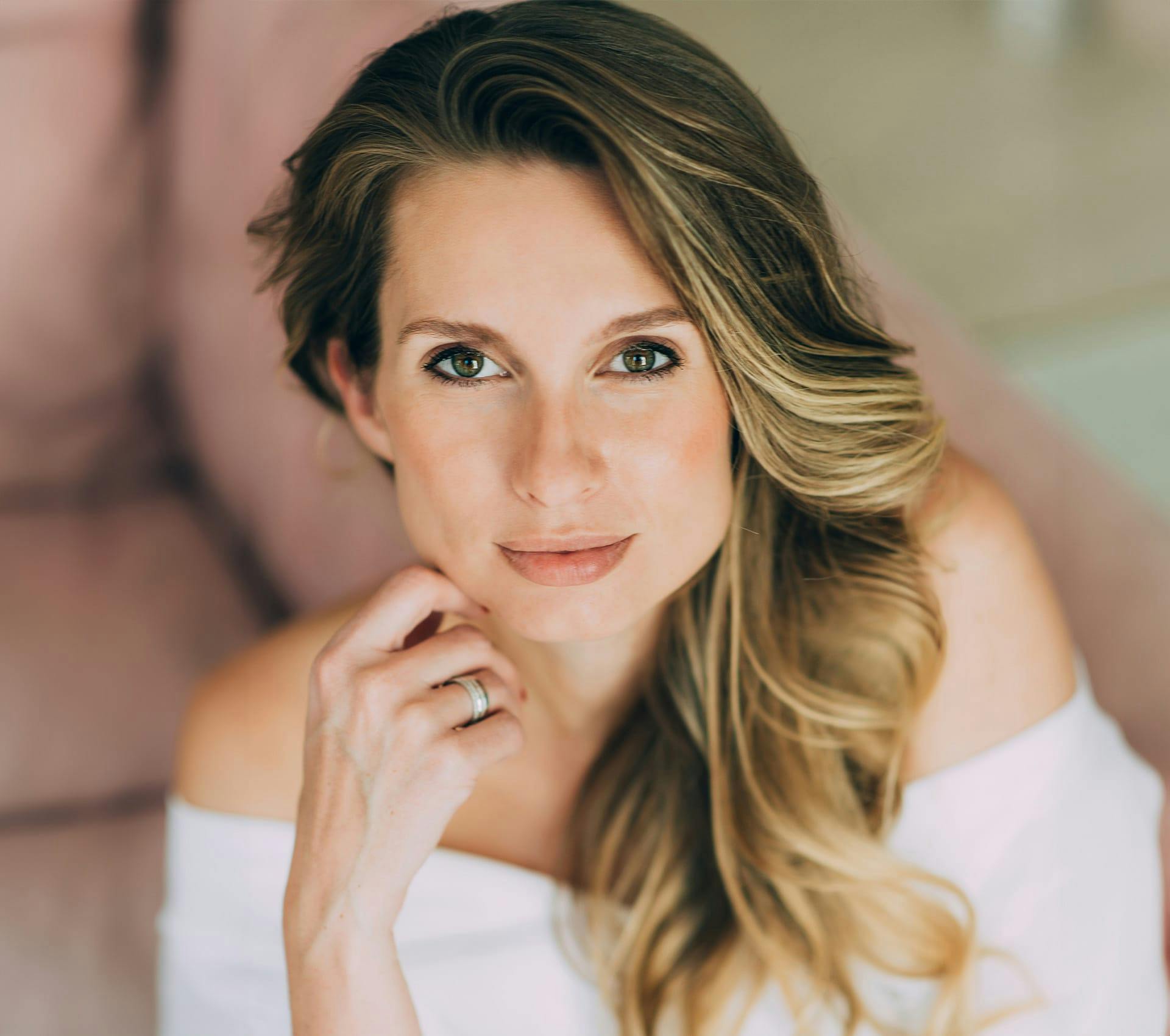 woman looking up with hand touching her jaw