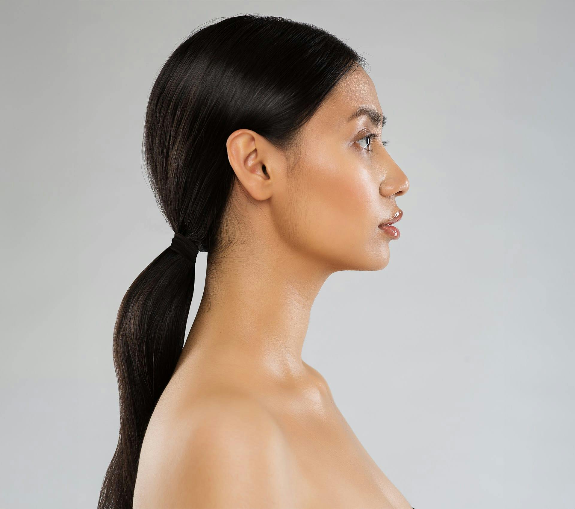 side angle of woman with low ponytail