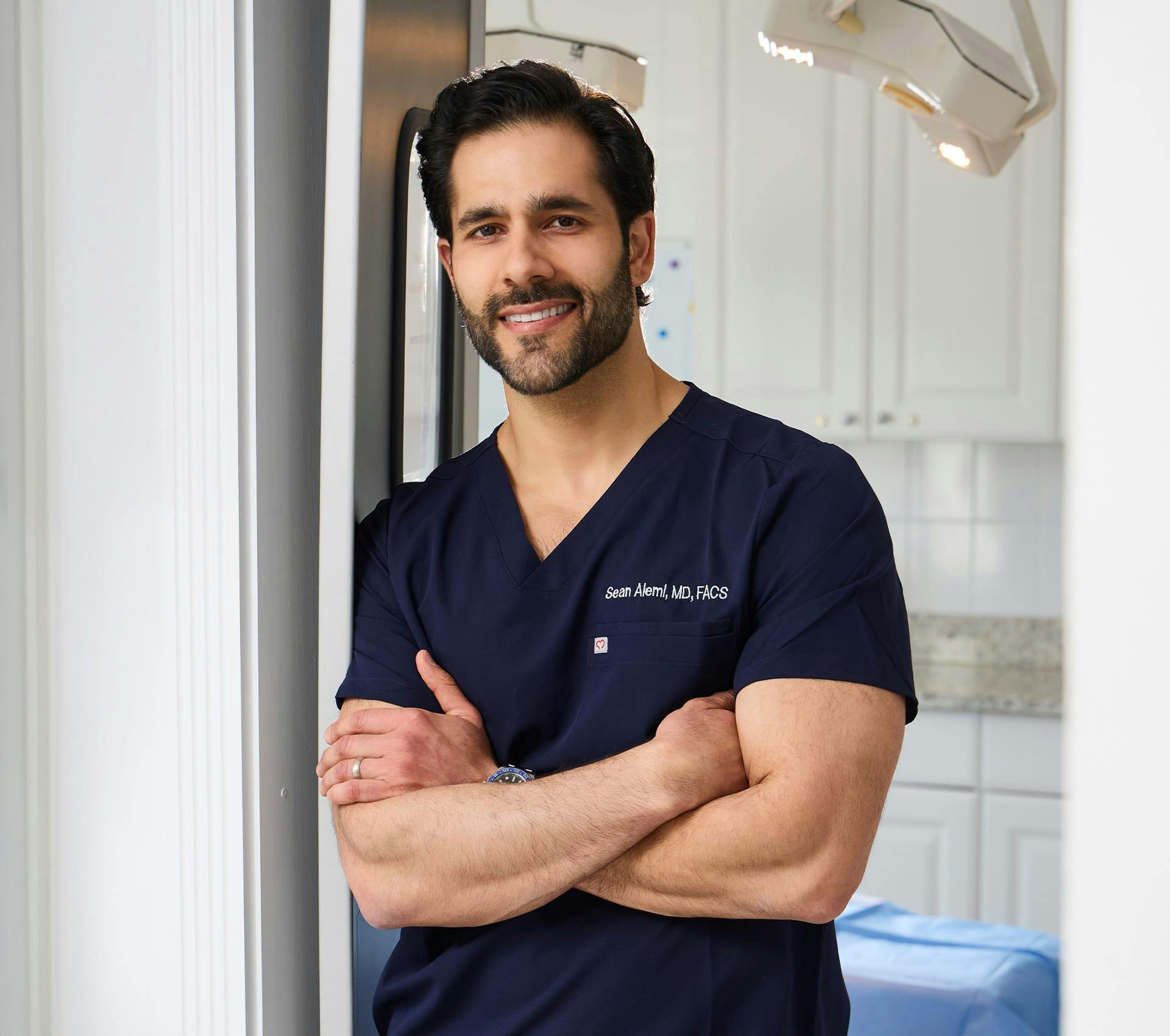 Dr. Alemi smiling and crossing his arms