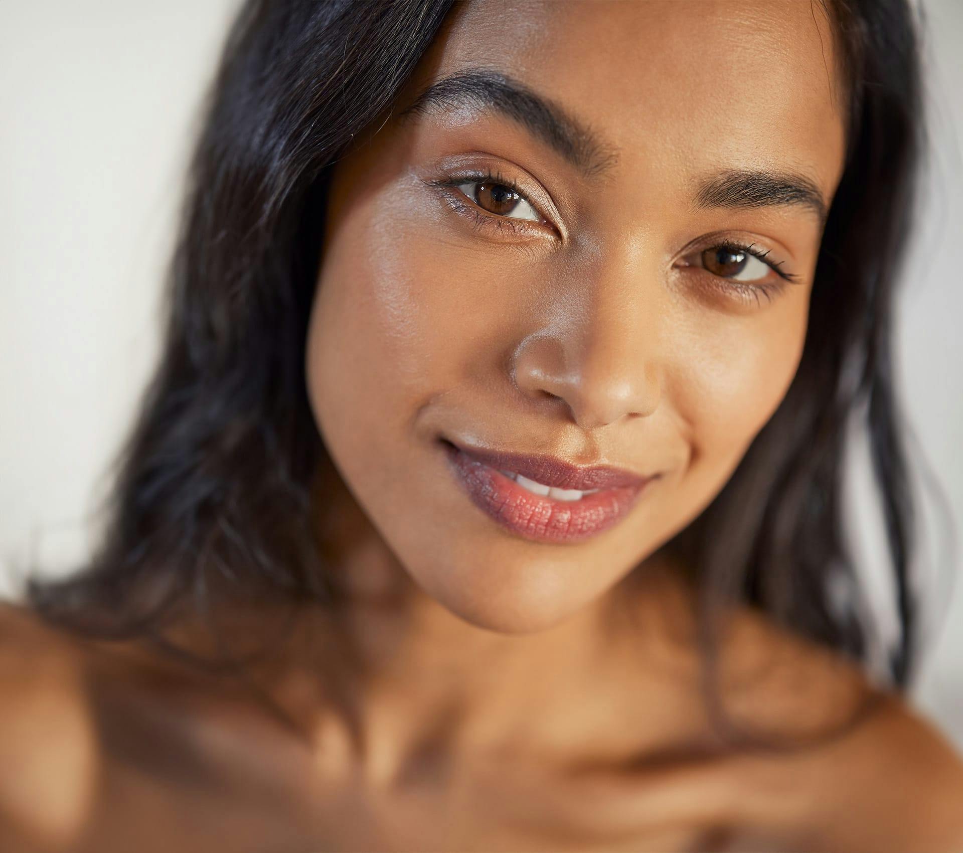 close up of woman looking forward with smooth skin