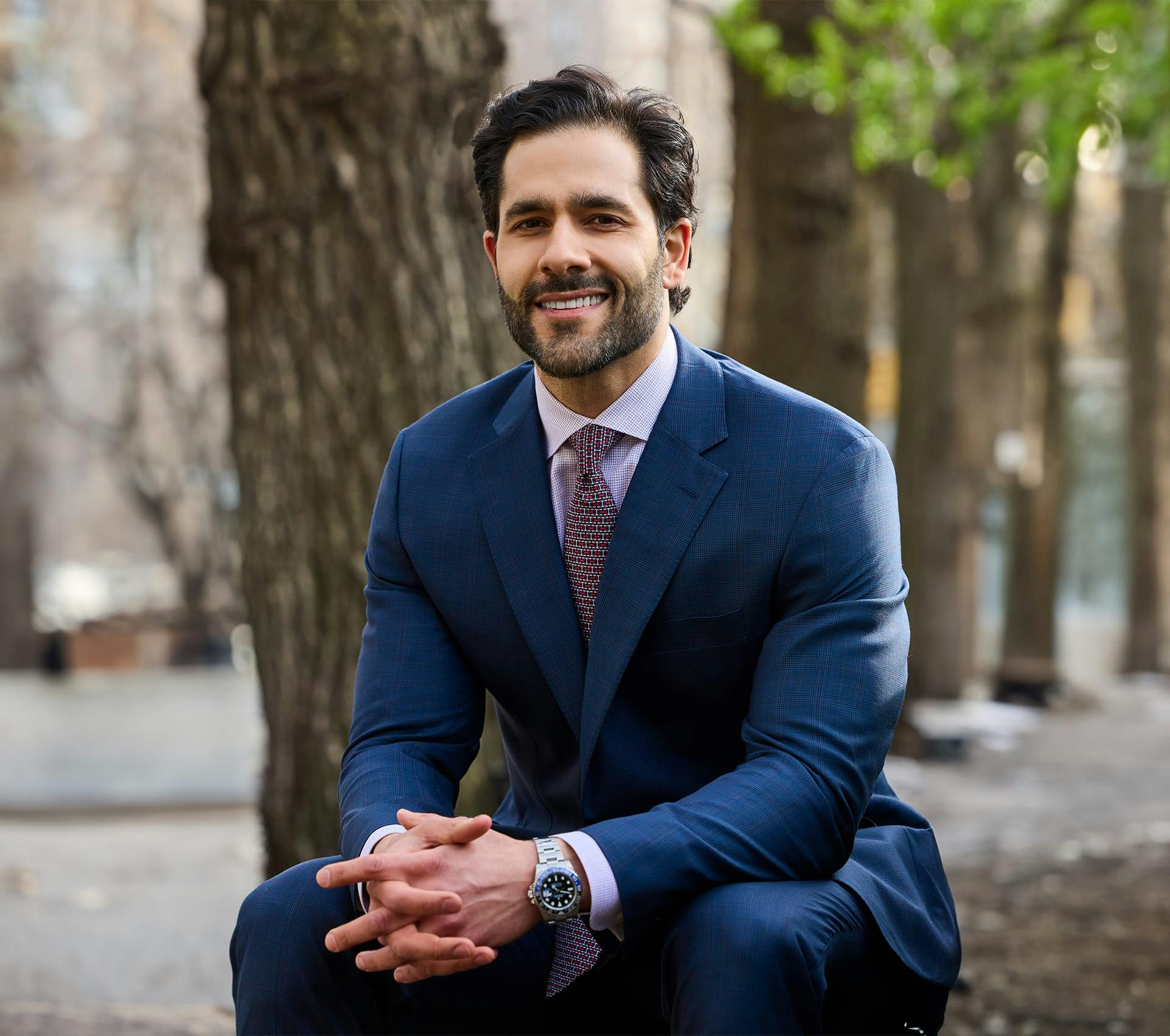 Dr. Alemi in suit sitting