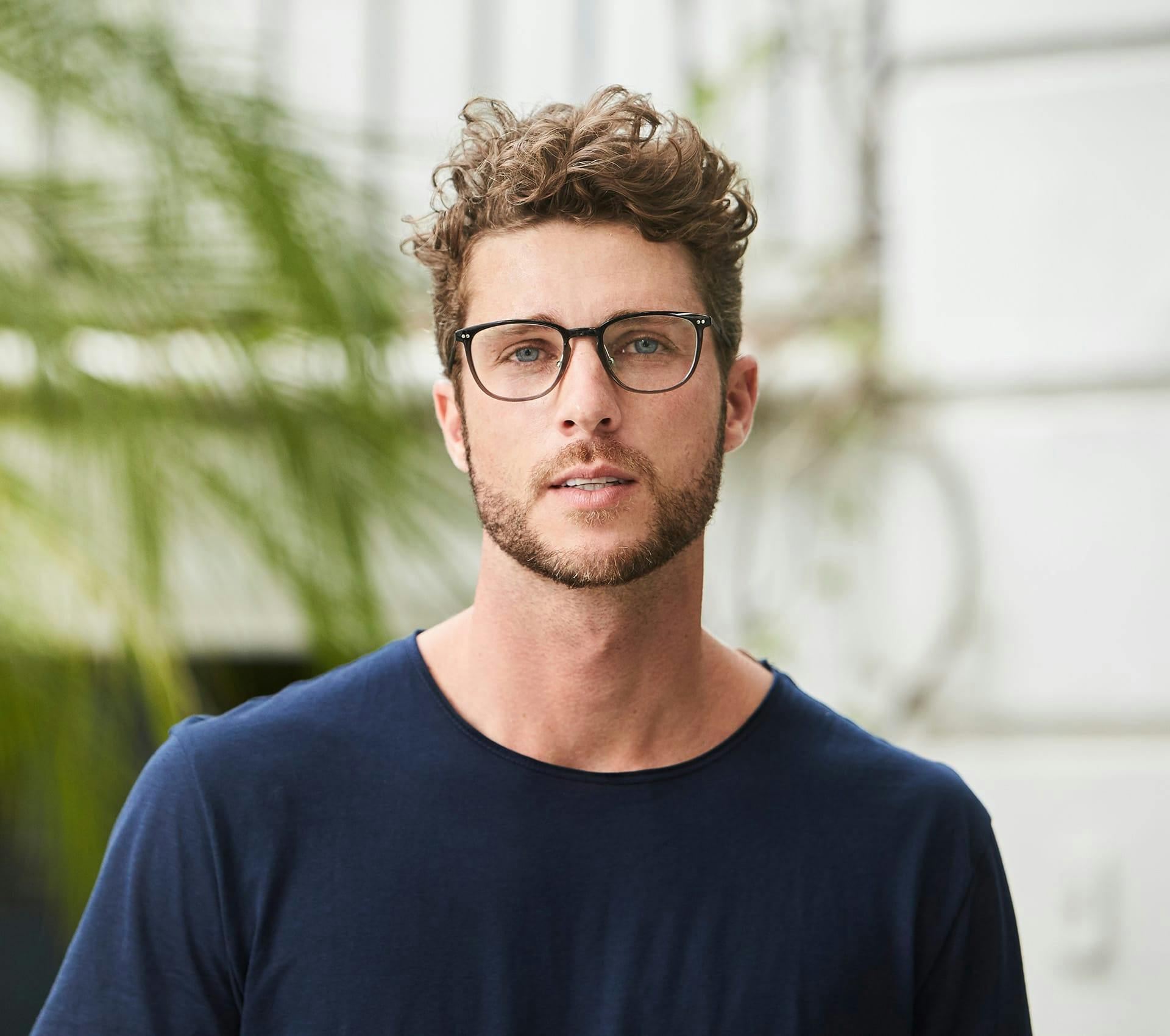 man in glasses with navy blue t-shirt