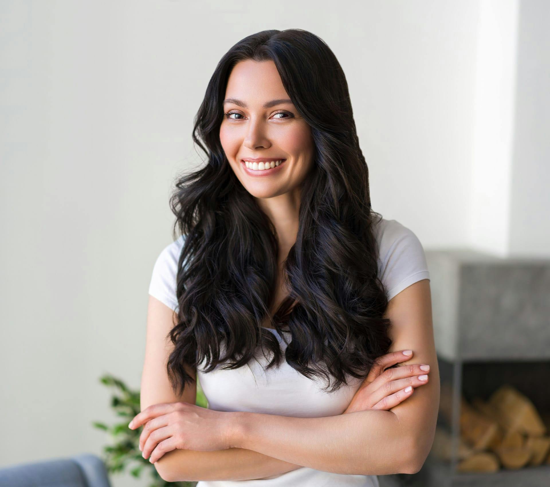 woman with long black hair crossing her arms