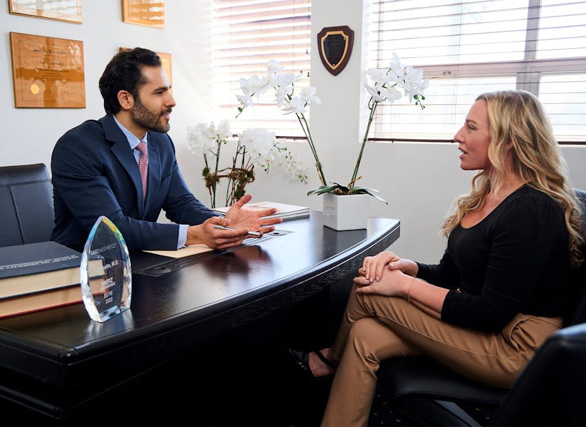 Dr. Alemi sitting across from client