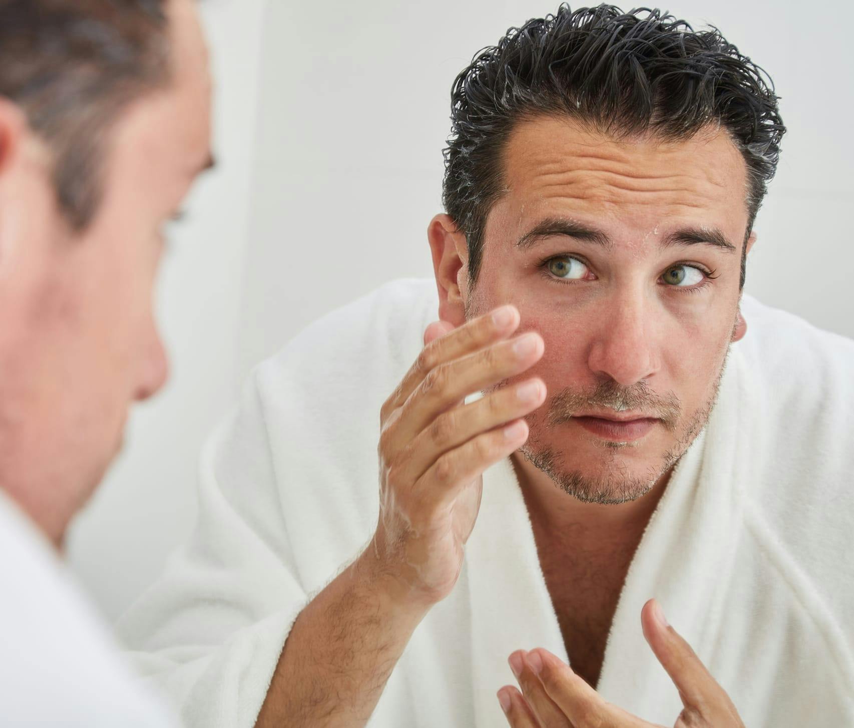Man looking at himself in the mirror