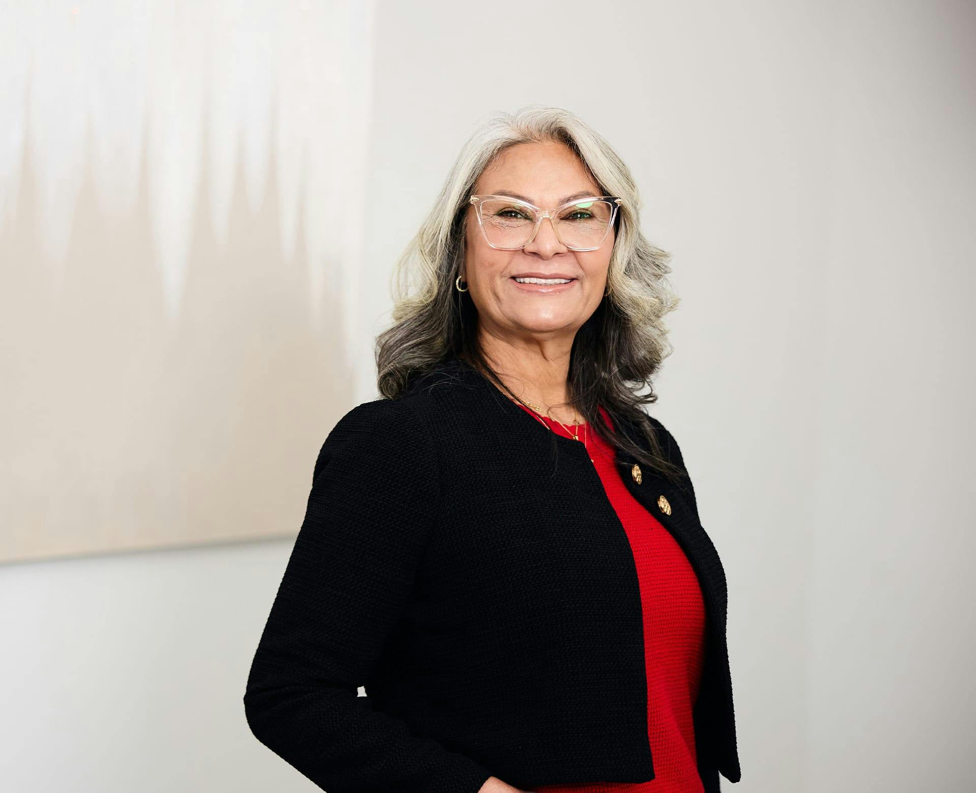 woman wearing a red shirt and black cardigan