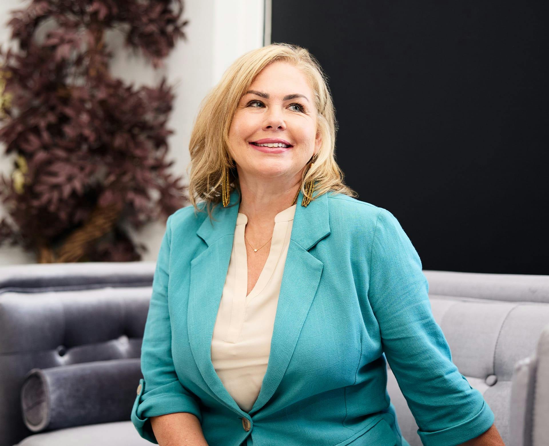 woman in a teal suit jacket