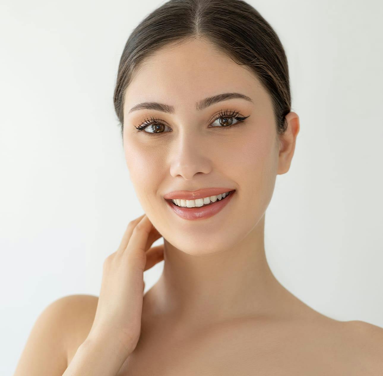 woman with her hair pulled back smiling