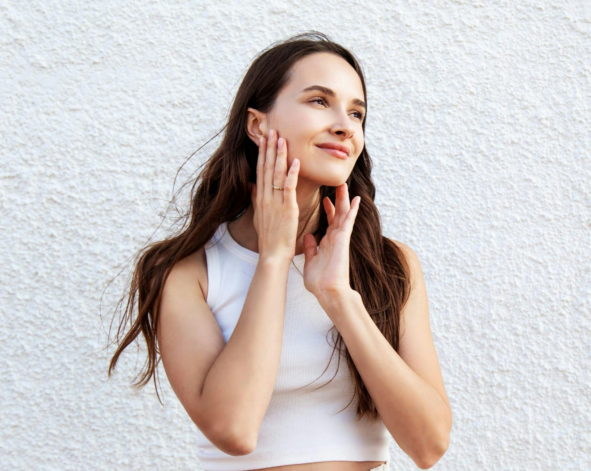 Woman smiling touching face