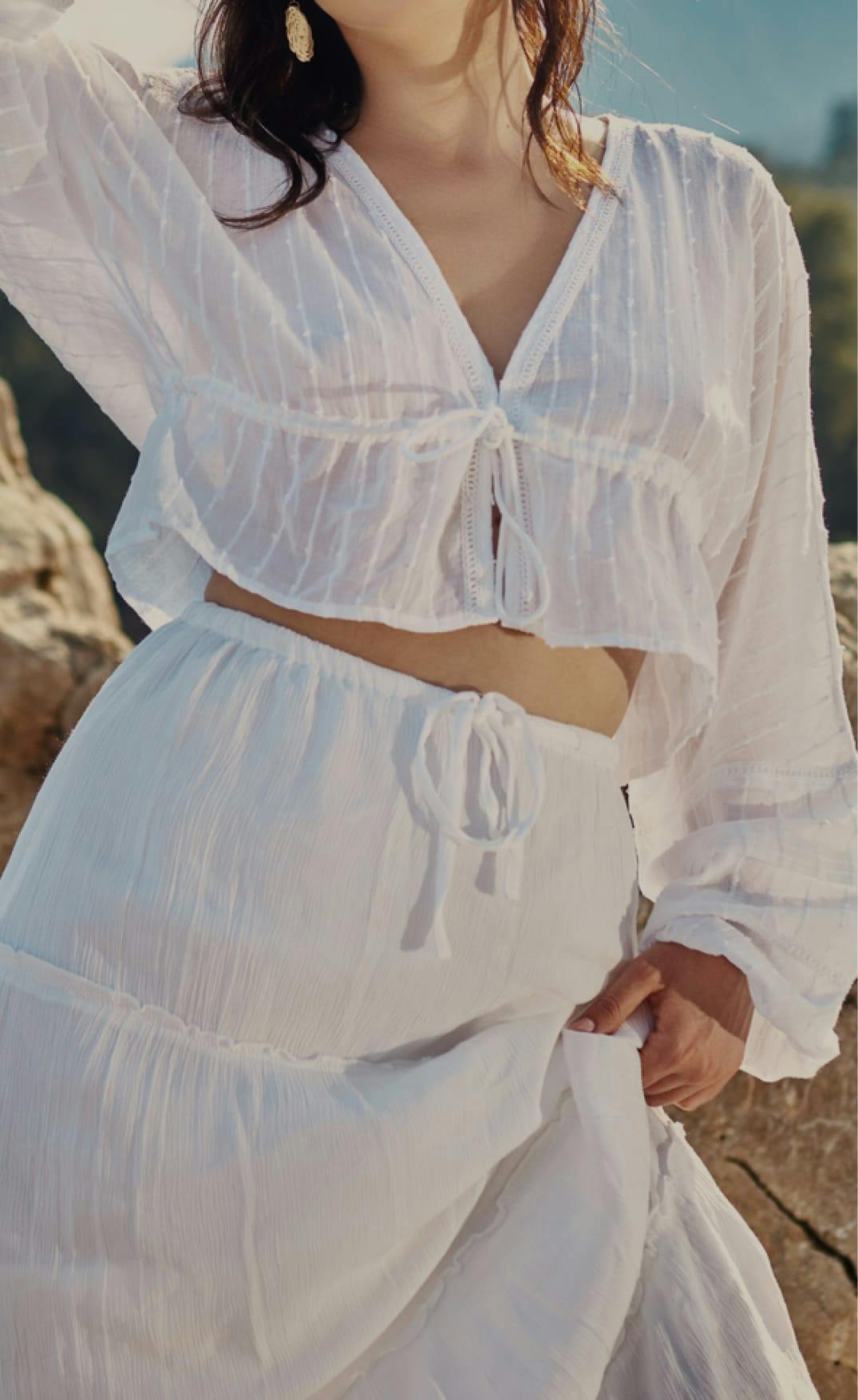 woman wearing a sheer white outfit