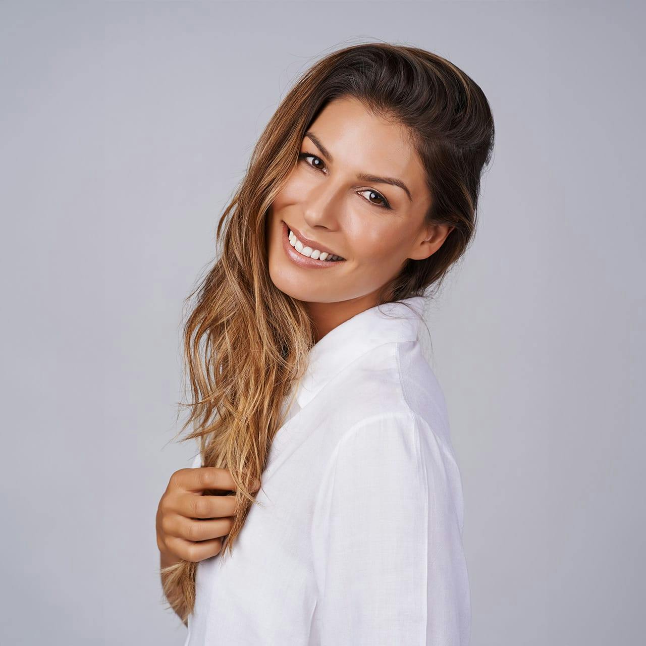 smiling woman in white shirt