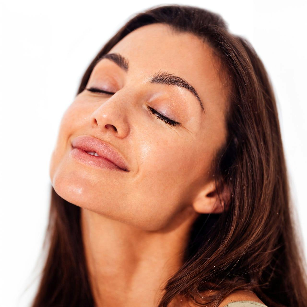 woman with brunette hair facing upwards
