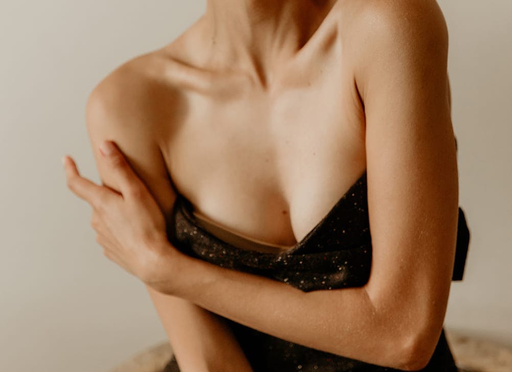 womans chest wearing a black dress