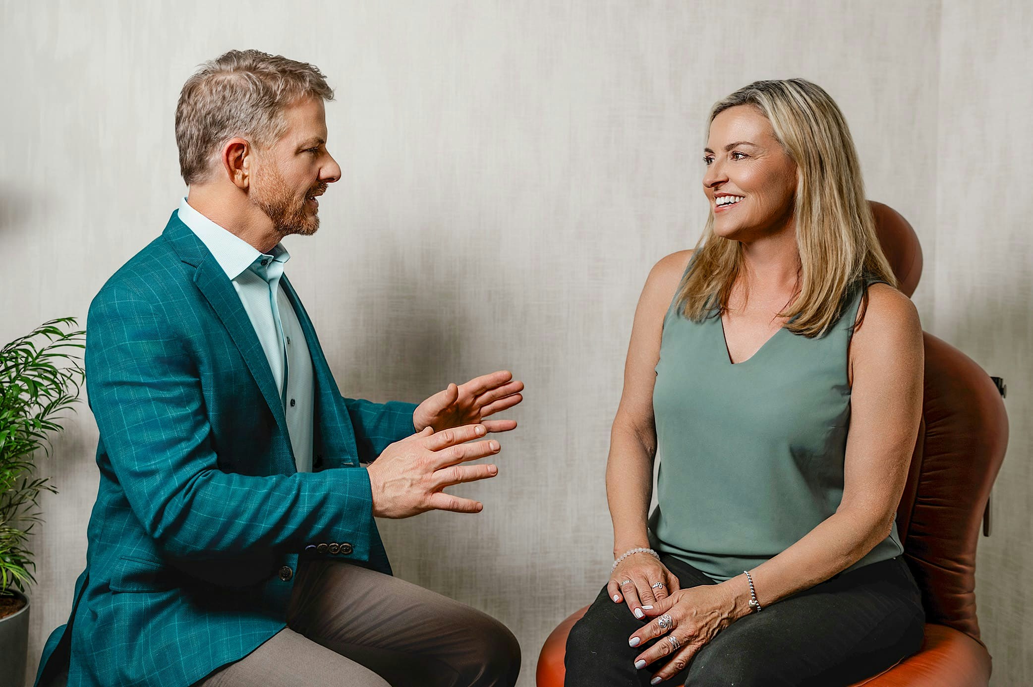 smiling woman sitting holding leg