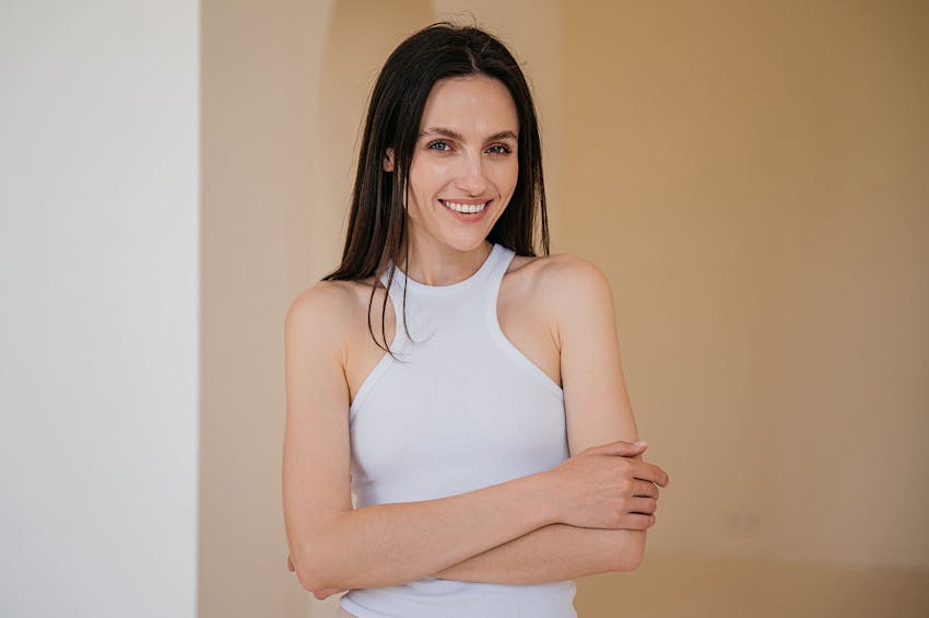 smiling woman with arms crossed