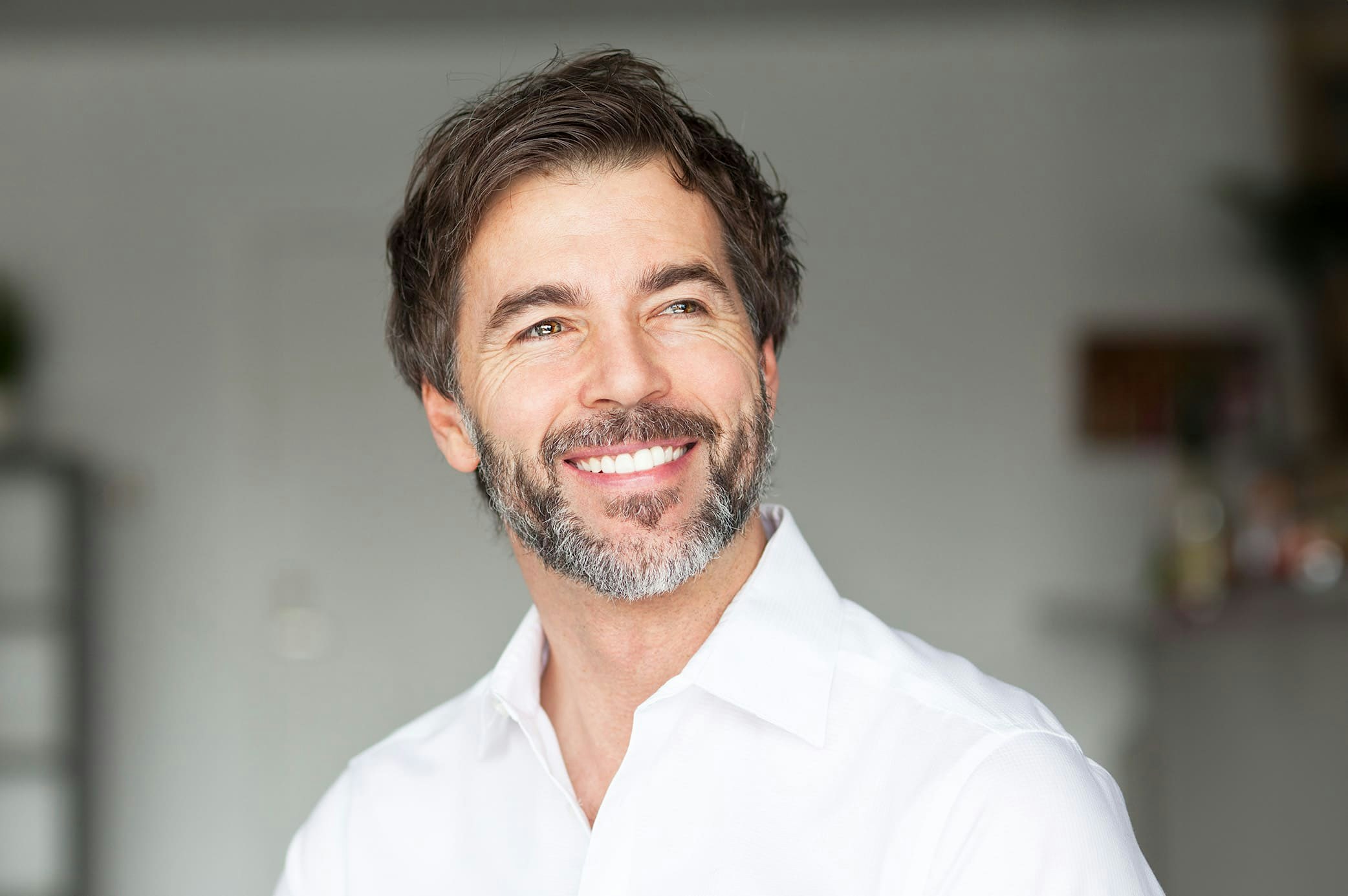 smiling man in white shirt