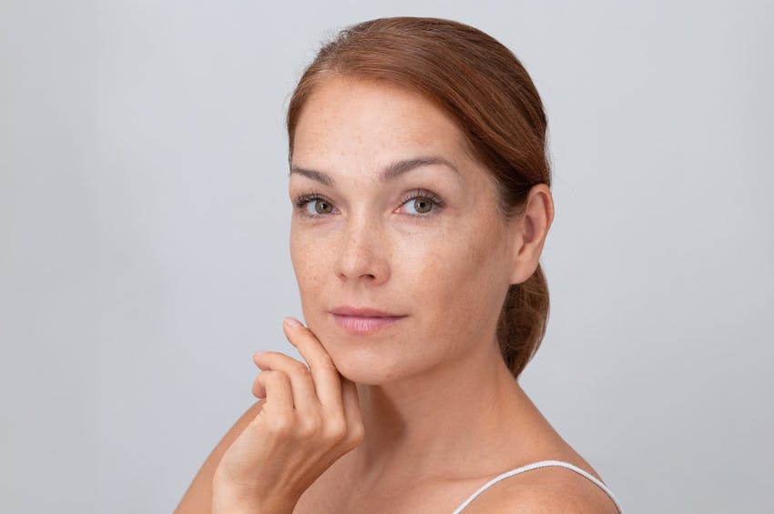 woman with hand under chin