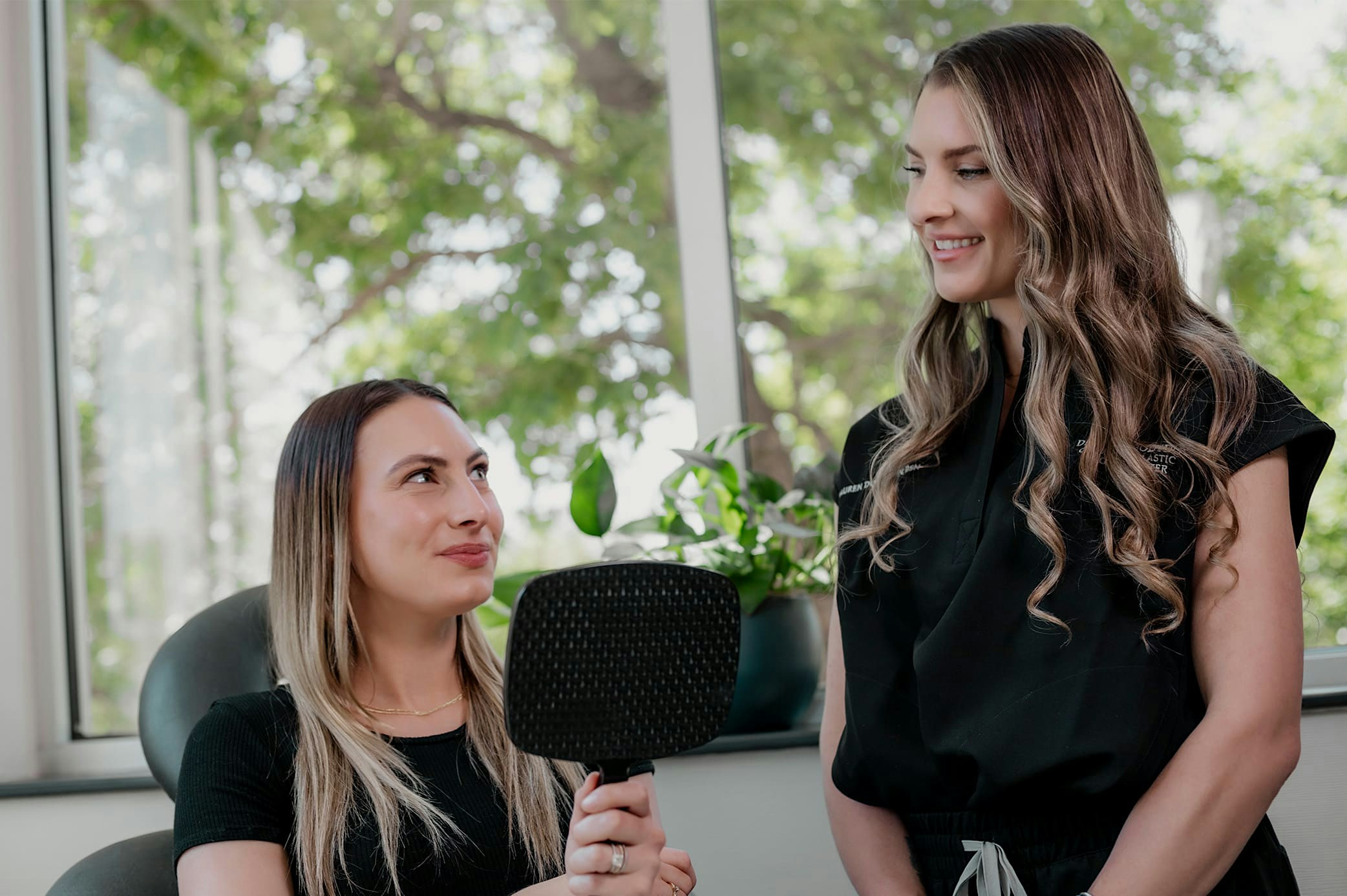 nurse showing patient the laser skin resurfacing machine
