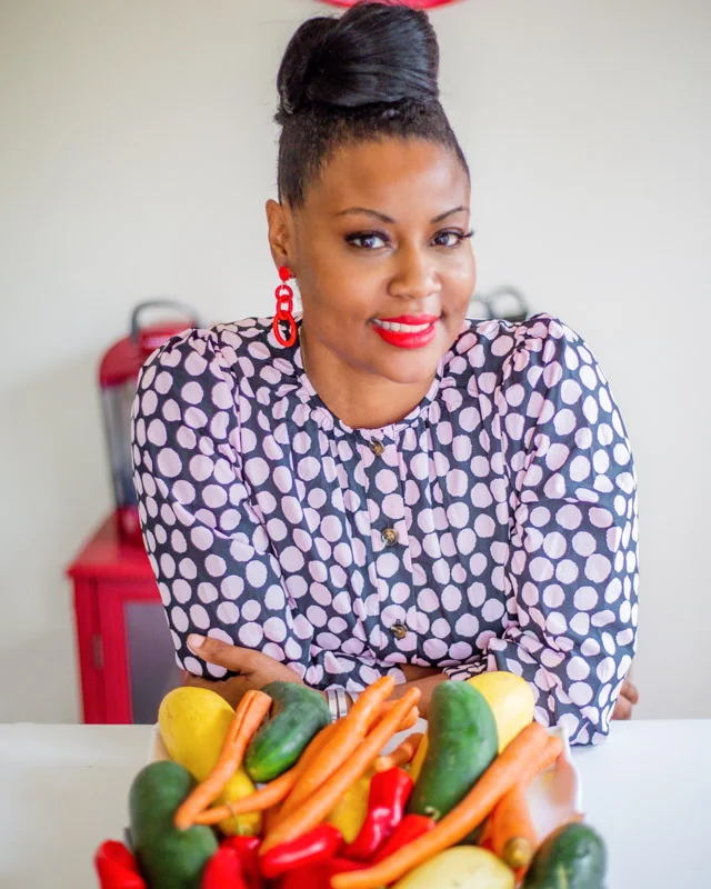 yolanda smiling with fruit in front