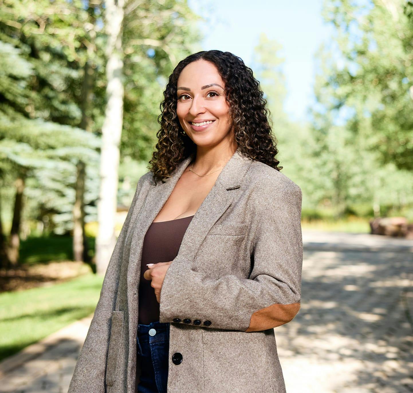 woman with curly hair in a long coat