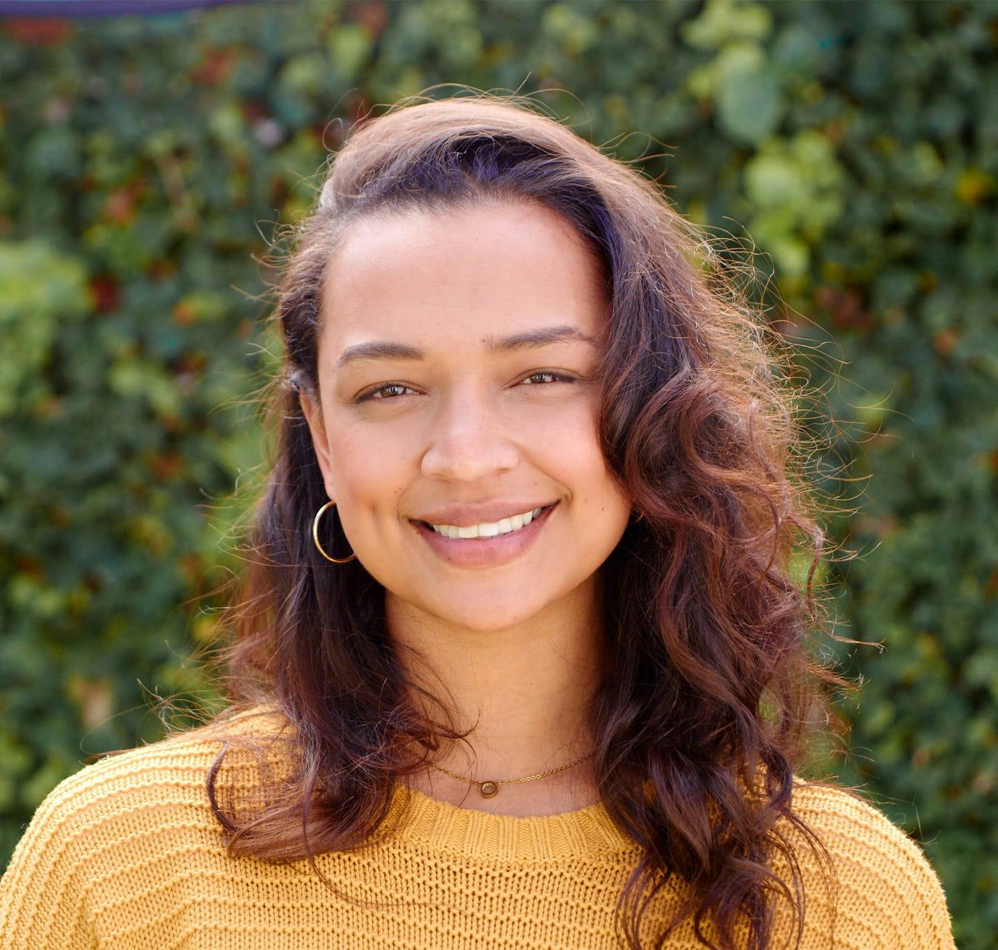 Young woman smiling outside