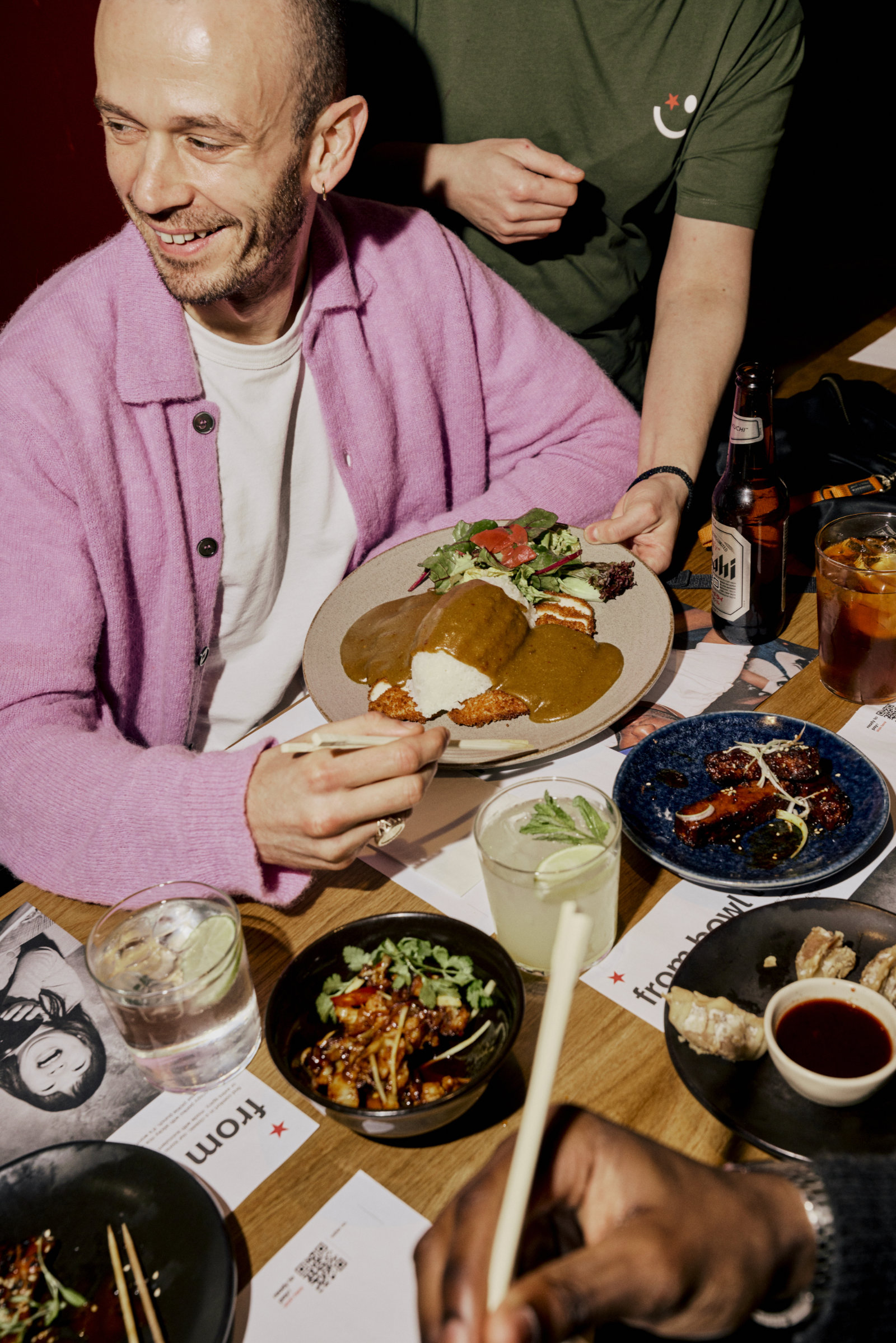 man at a table with assorted wagamama dishes
