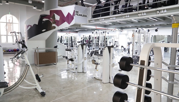 Dynamik Gym Bright gym with various fitness equipment, including weight machines and free weights.