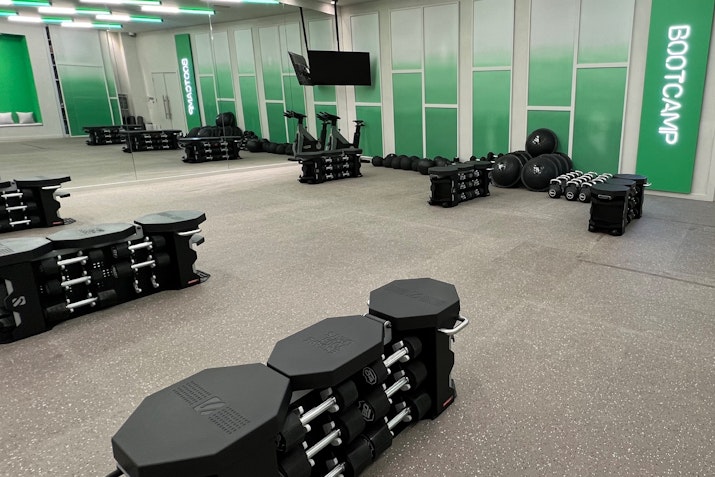 Bootcamp fitness room with dumbbells, barbells, and exercise equipment