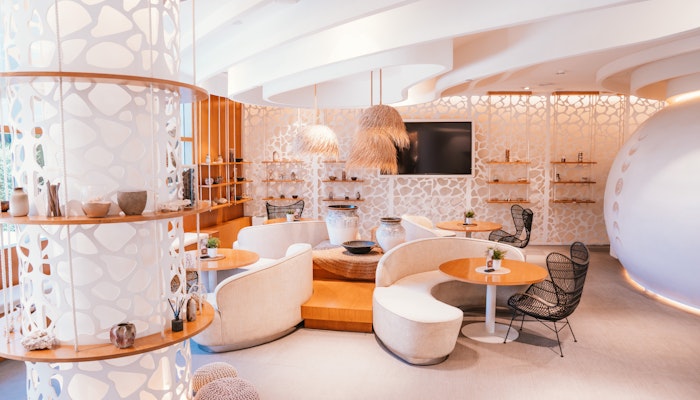 Soul Bowl Stylish and modern interior of a lounge with curved white walls, cozy seating, and decorative shelves