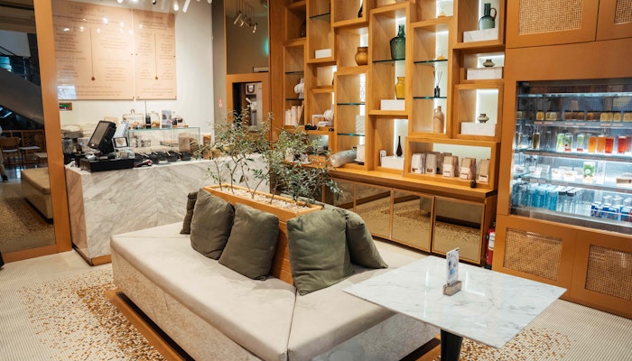 Qure Charming café with wooden shelving, a cozy seating area, and a minimalist design