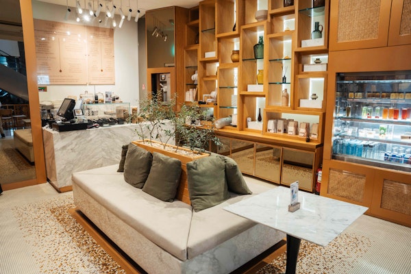 Charming café with wooden shelving, a cozy seating area, and a minimalist design