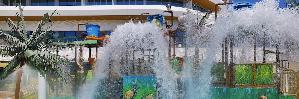 Waldorf Astoria Lusail, Doha Water play area with large water features, colorful animal-themed murals, and a hotel building in the background.