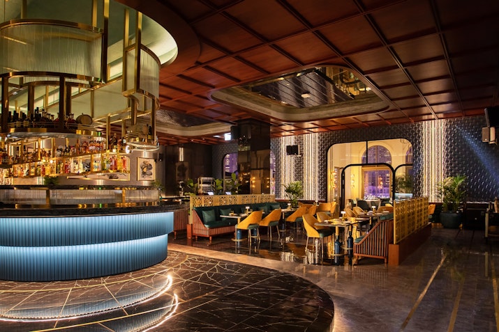 Stylish bar and dining area with modern decor and ambient lighting.
