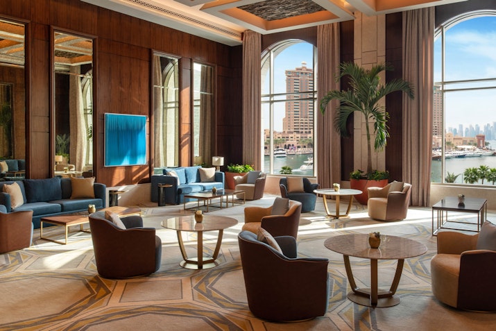Luxurious lounge area with comfortable seating and large windows offering a city view