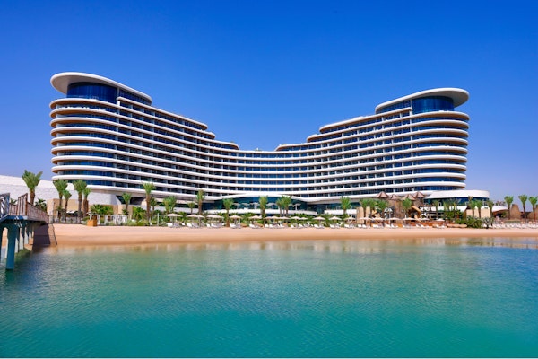 Waldorf Astoria Lusail Doha Luxury beachfront hotel with modern architecture and clear blue skies