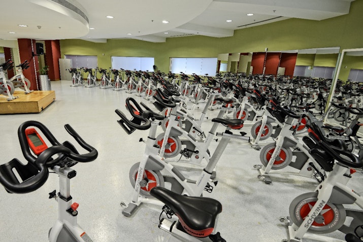 Spinning studio with stationary bikes and large windows
