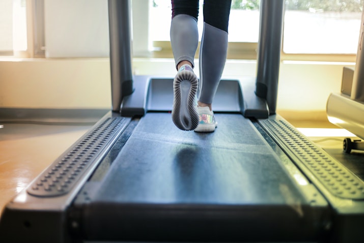 Close-up of a person walking on a treadmill.