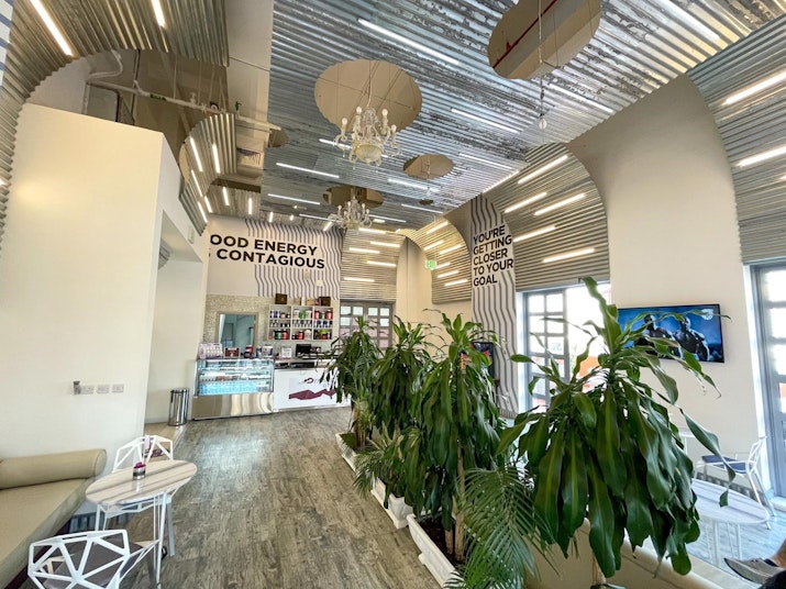 Nutritious Food Modern fitness studio with motivational signage, plants, and a clean, industrial-style interior.